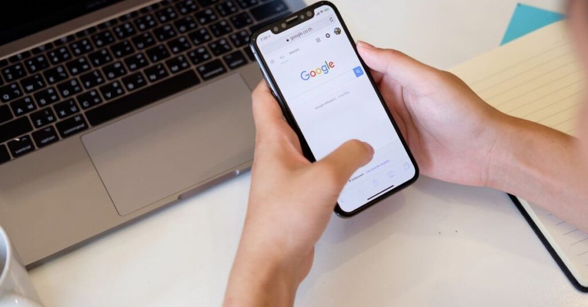 Person using smartphone with Google search