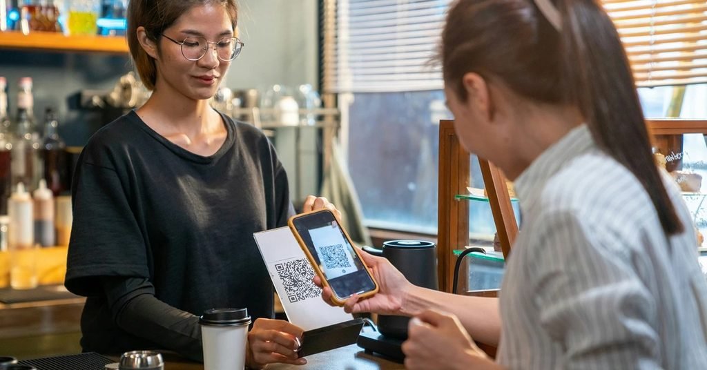 Customer scanning QR code with smartphone