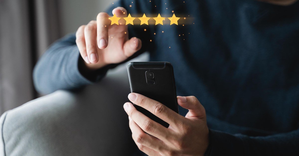 Customer giving five star review on smartphone